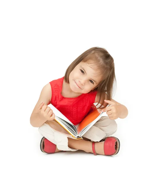 Kleines Mädchen liest ein Buch Stockbild