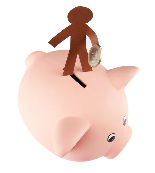 Paper figure saving money on a piggy bank — Stock Photo, Image