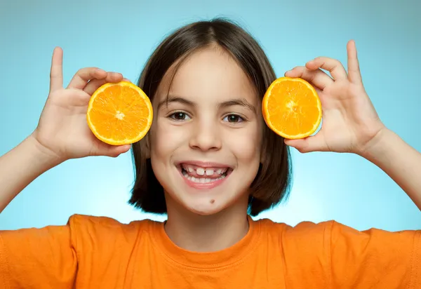 Liten flicka med apelsiner — Stockfoto