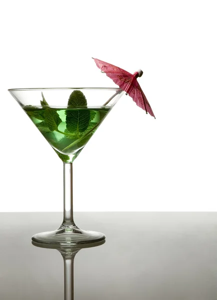 Green cocktail with umbrella — Stock Photo, Image
