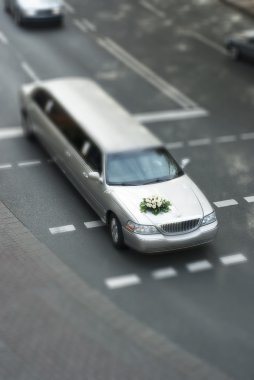 Tilt shift wedding limousine on street clipart