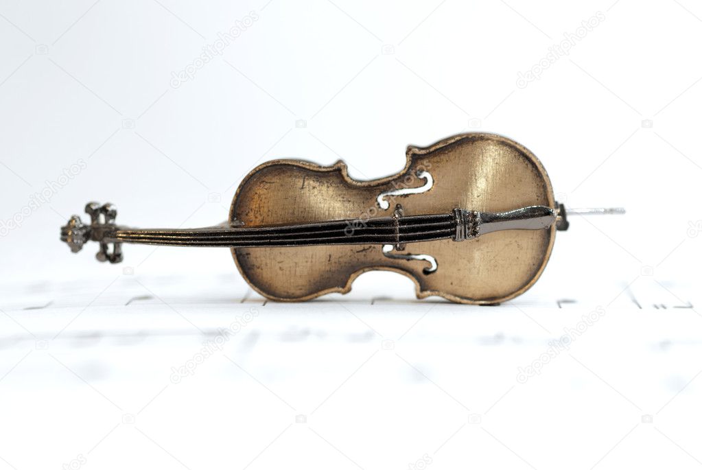 Classical Cello Placed On Music Sheet
