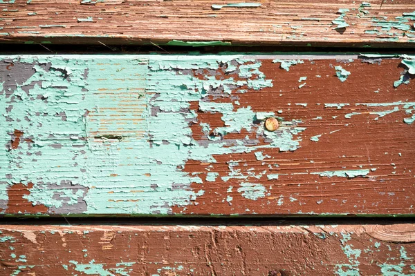 stock image The old planks with peeling multicolor paint