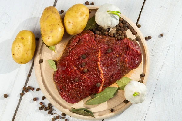 Raw steak spiced with herbs ready for baking — Stock Photo, Image