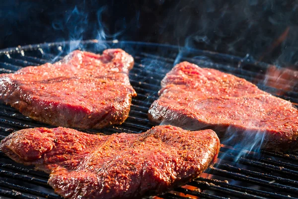BBQ with fiery steak on the grill — Stock Photo, Image