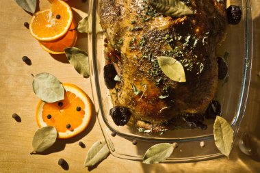 Roasted chicken with orange fruit and dried plums clipart