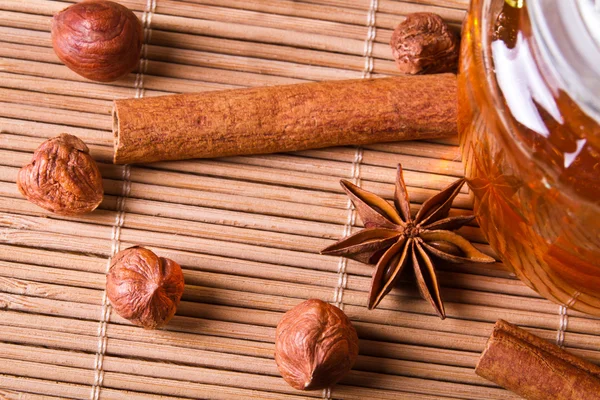 stock image Closeup nuts and honey on wooden bamboo mat