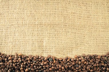 Old burlap and coffee beans background clipart