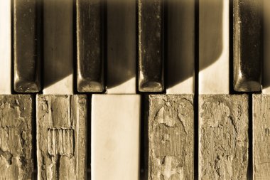 Closeup old piano keys in sepia toned clipart