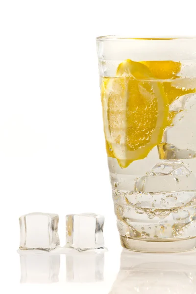 stock image Ice cubes and lemon drink in glass