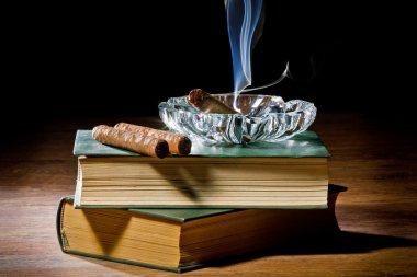 Blue smoke from cigar with ashtray and two books volume clipart