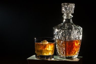 Whisky with glass and carafer on book clipart