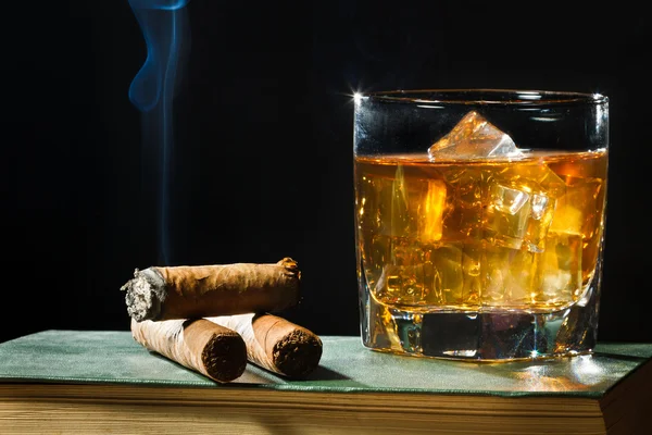 Tree cigar and whisky with ice in glass — Stock Photo, Image