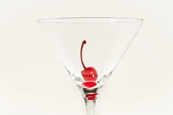 One cherry in empty glass isolated on white background — Stock Photo, Image