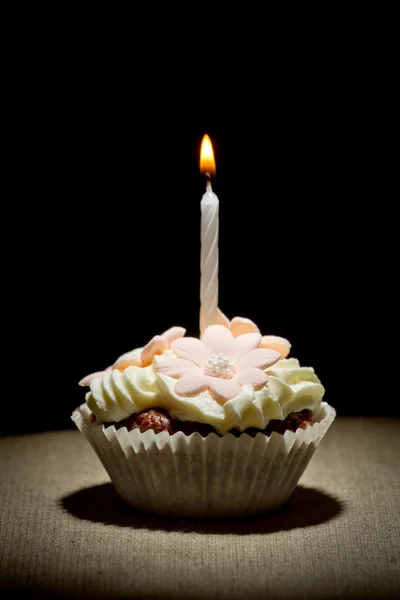 stock image Birthday muffin with small burning candle