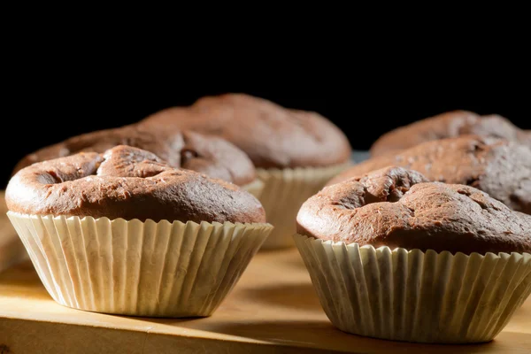 Closeup chocolate muffin on wooden board — Stock Photo, Image