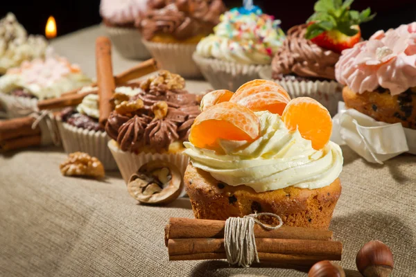 Various muffin with cream and nuts — Stock Photo, Image
