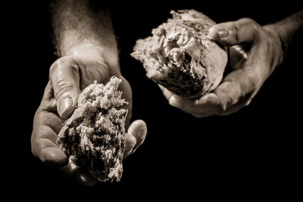 Mão humana dando um pedaço de pão — Fotografia de Stock
