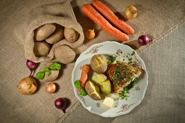 stock image Vegetables, jacket potatoes, and roast chicken in rural meal