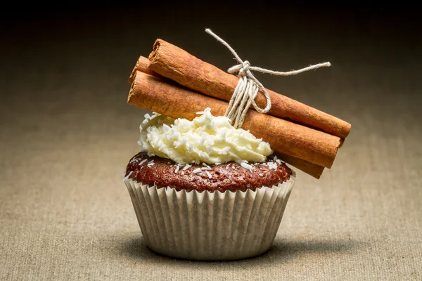 Brown muffin with cinnamon bark and coconut — Stock Photo, Image