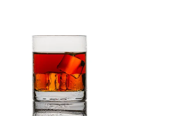 Glass with ice cubes and whisky on white background — Stock Photo, Image