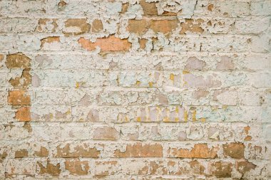 Old brick wall with peeling paint clipart