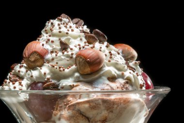 Closeup hazelnut ice cream in glass bowl clipart
