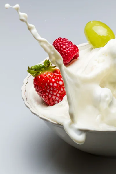 Milk splash with fresh fruits — Stock Photo, Image