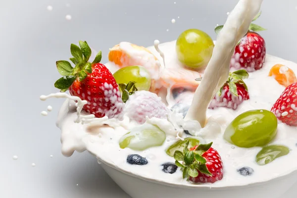 Fresh fruits and milk splash — Stock Photo, Image