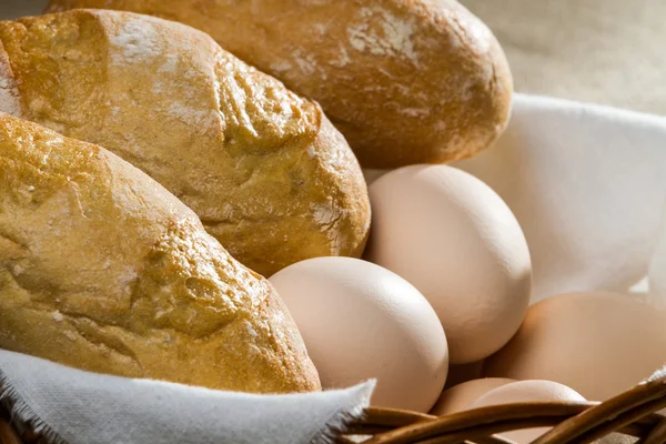 Closeup eggs and easter bread in wicker basket — Stock Photo, Image