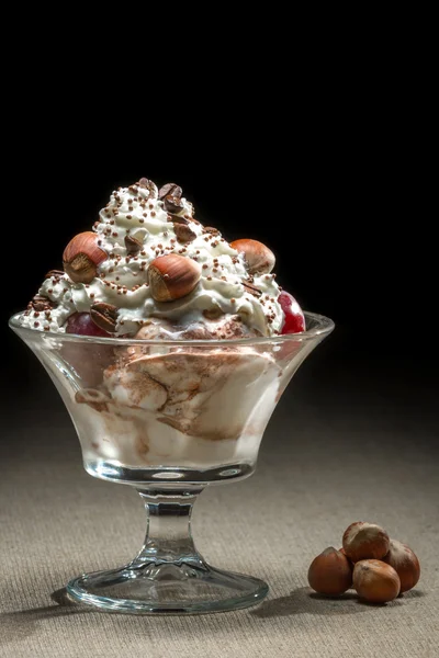 Ice cream and hazelnut in glass bowl — Stock Photo, Image