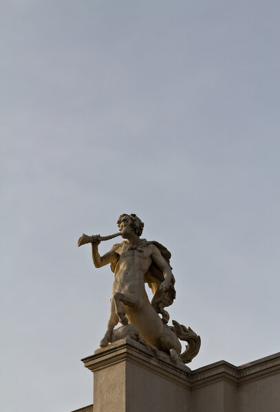 A minotaur sculpture indicating to play a trumpet-like instrument on Vienna's burgtheater