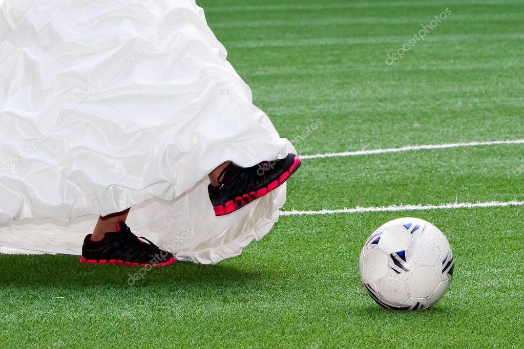 Bride feet with soccer ball