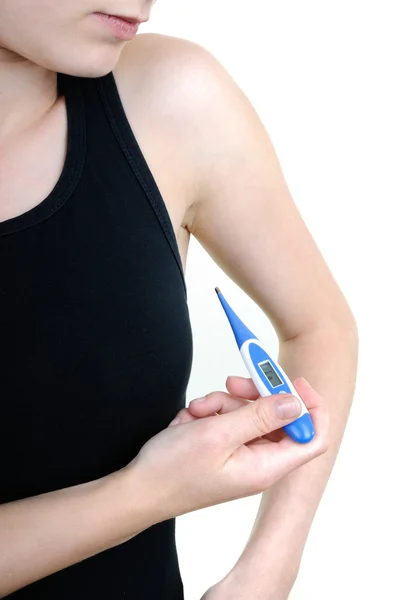 Young woman with a thermometer measures temperature — Stock Photo, Image