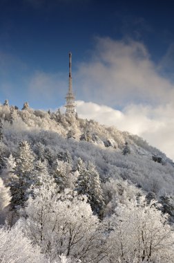 Tv transmitter Sitno in Winter landscape clipart