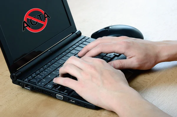 stock image Anti Acta symbol on netbook