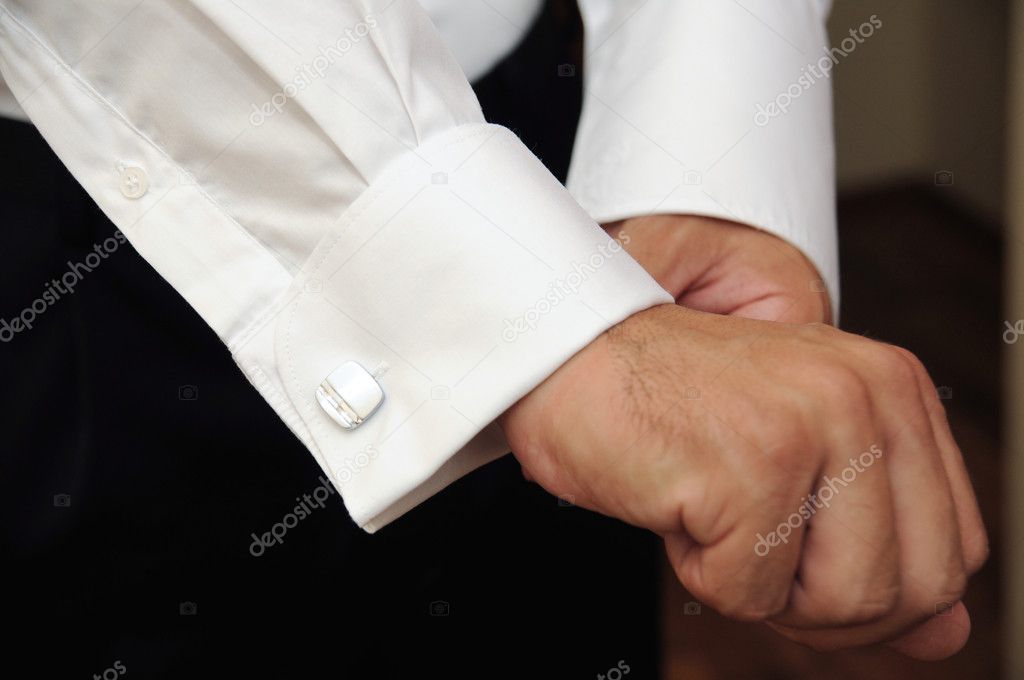 Groom Hands of wedding groom getting ready in suit