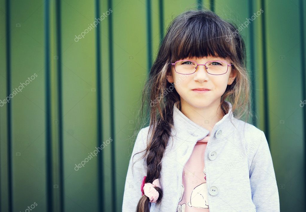 Portrait of brunette toddler girl in glasses
