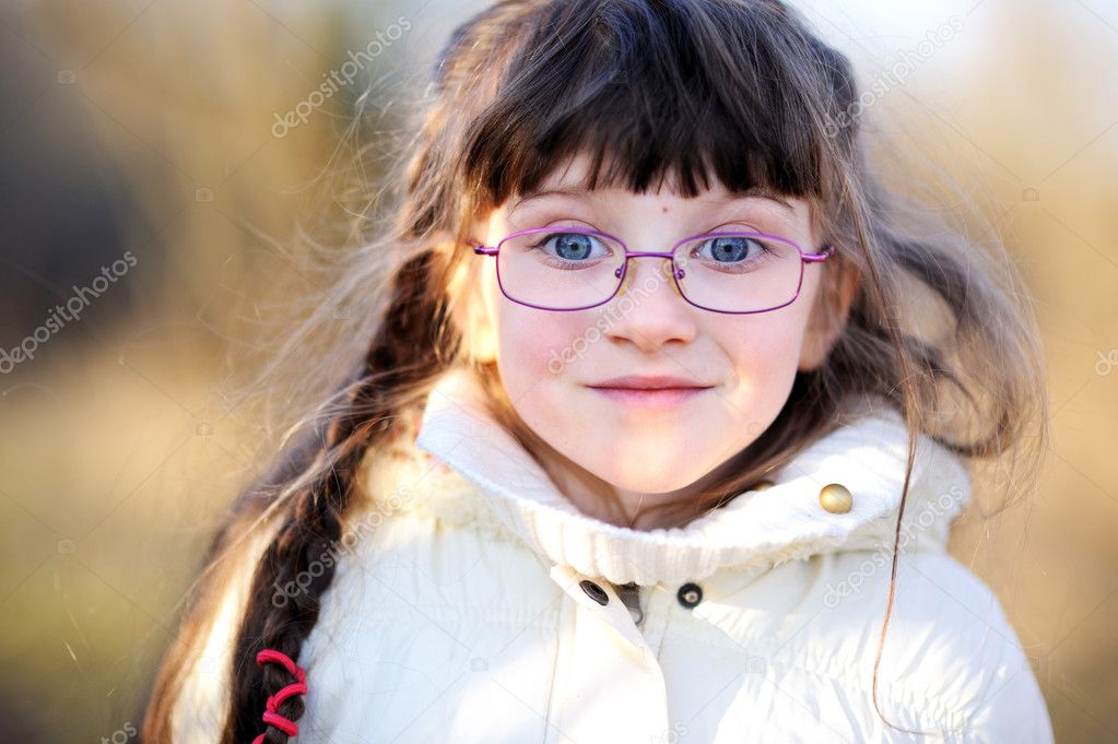 A portrait of little child girl in glasses