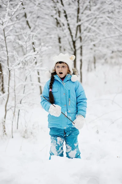 Adorable little girl in snow winter forest — Stock Photo, Image