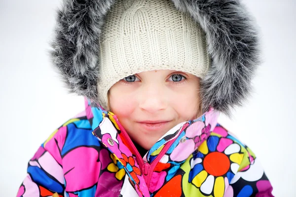 Portrait of toddler girl in colorful snowsuit — Stock Photo, Image