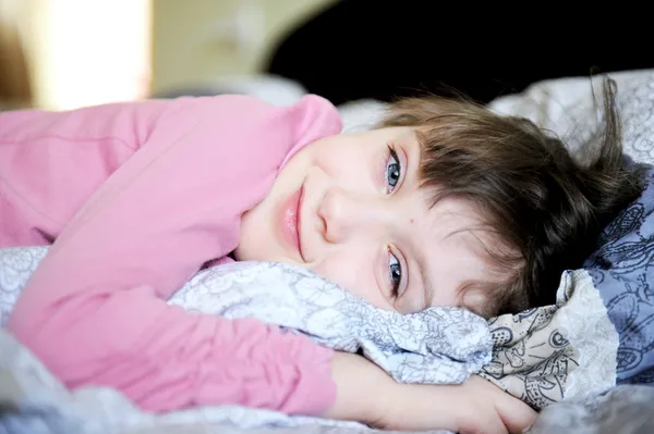 Adorable niñita relajándose en la cama — Foto de Stock