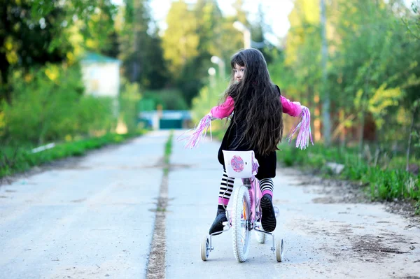 Fancy little girl riding her pink bike — Stock Photo, Image