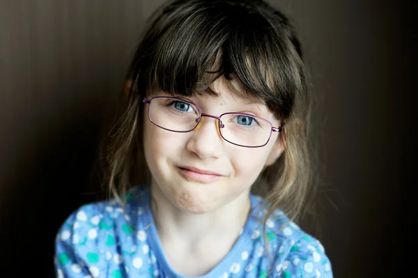 Portrait of unhappy little girl on dark background — Stock Photo, Image