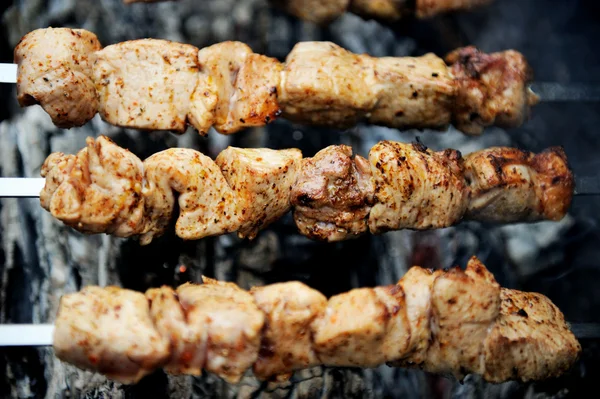 stock image Juicy slices of meat with spices cooking on fire