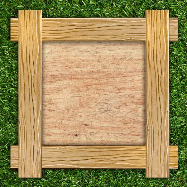 Wooden board on grass — Stock Photo, Image