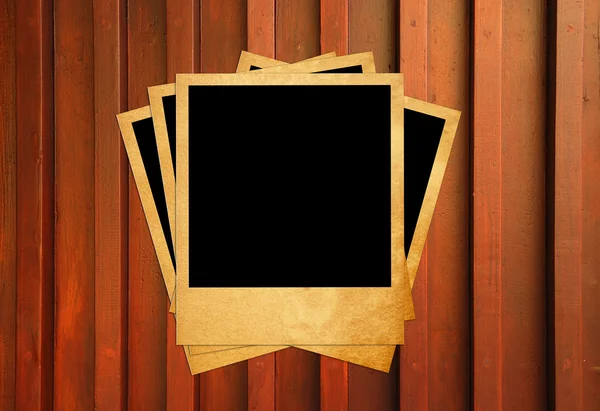 Blank instant photo frames on old wooden background. — Stock Photo, Image