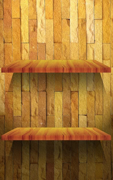 Empty wood shelf on stone wall — Stock Photo, Image