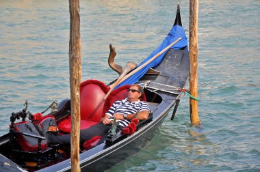 Man on Gondola Having a Rest clipart