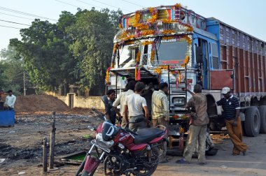 Repairing of an Indian Old Rusty Truck clipart